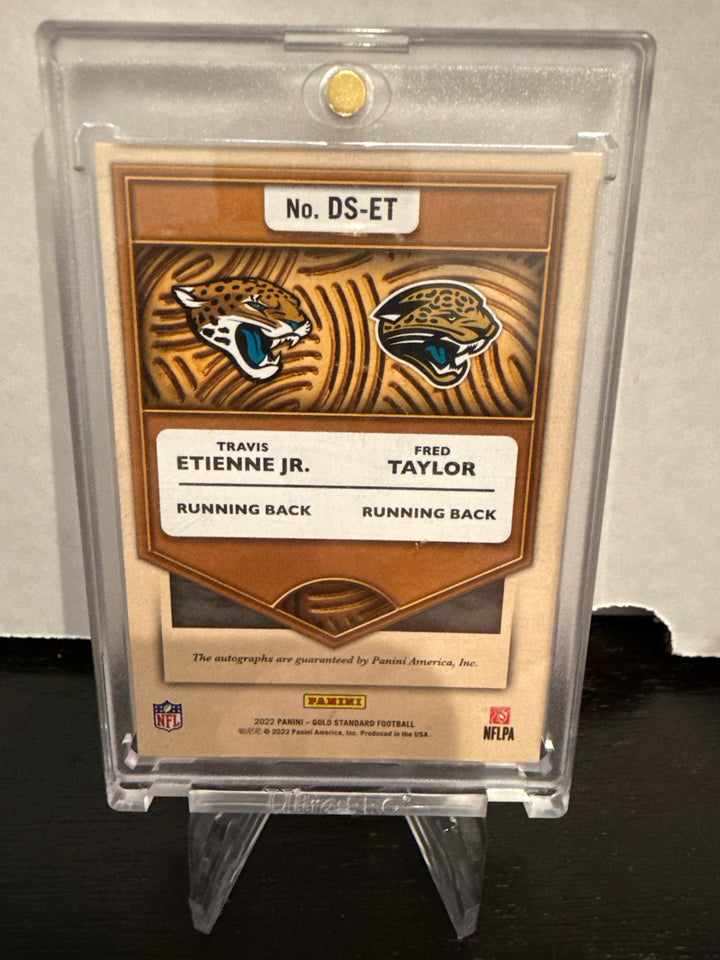 Travis Etienne/Fred Taylor 2022 Panini Gold Standard Double Standard Dual Auto, 20/25