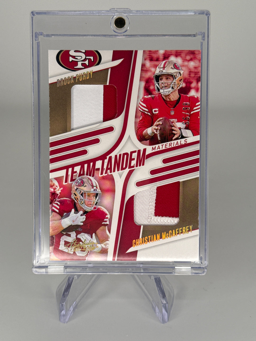 Brock Purdy/Christian McCaffrey 2025 Panini Absolute Team Tandem Materials Dual Relic, 86/99